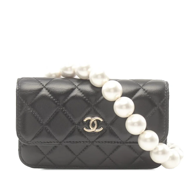 Chanel bags with iconic gold chainsBlack Chanel Quilted Calfskin Maxi Pearls Clutch With Chain Crossbody Bag