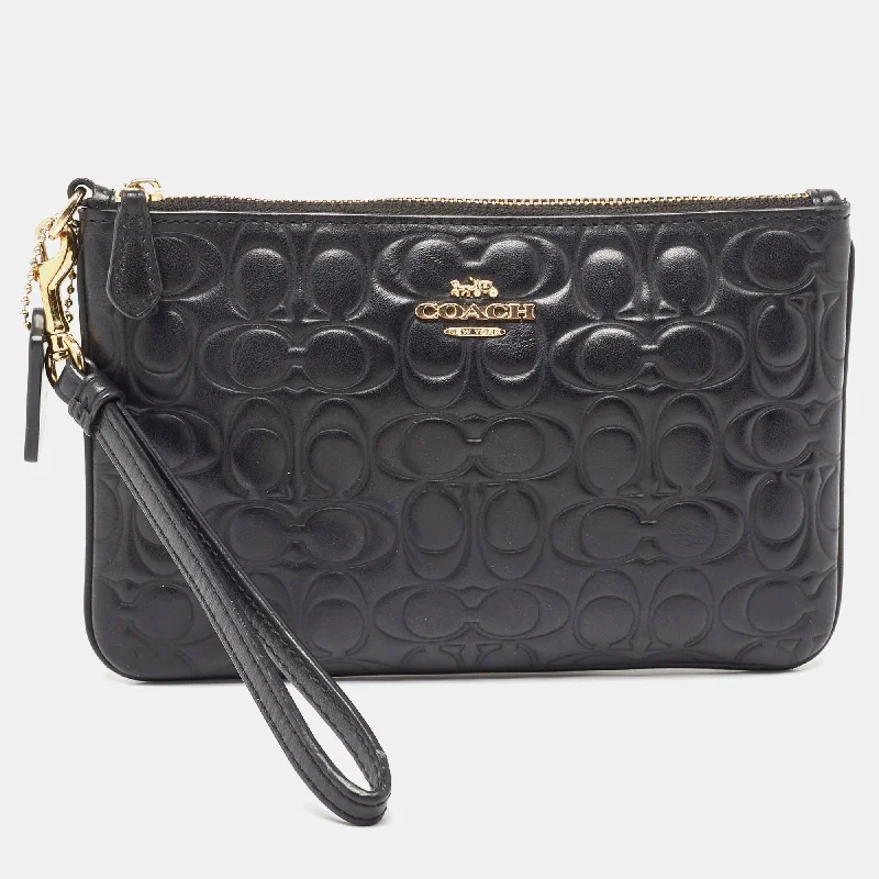 Coach Tabby bags with a classic turnlock closure for a timeless styleBlack Signature Embossed Leather Wristlet Pouch