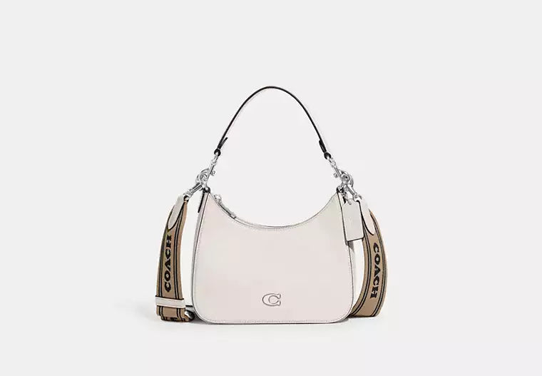 Ladies Coach Tabby bags with a textured leather surface for a more tactile lookCoach Hobo Crossbody Bag With Signature Canvas