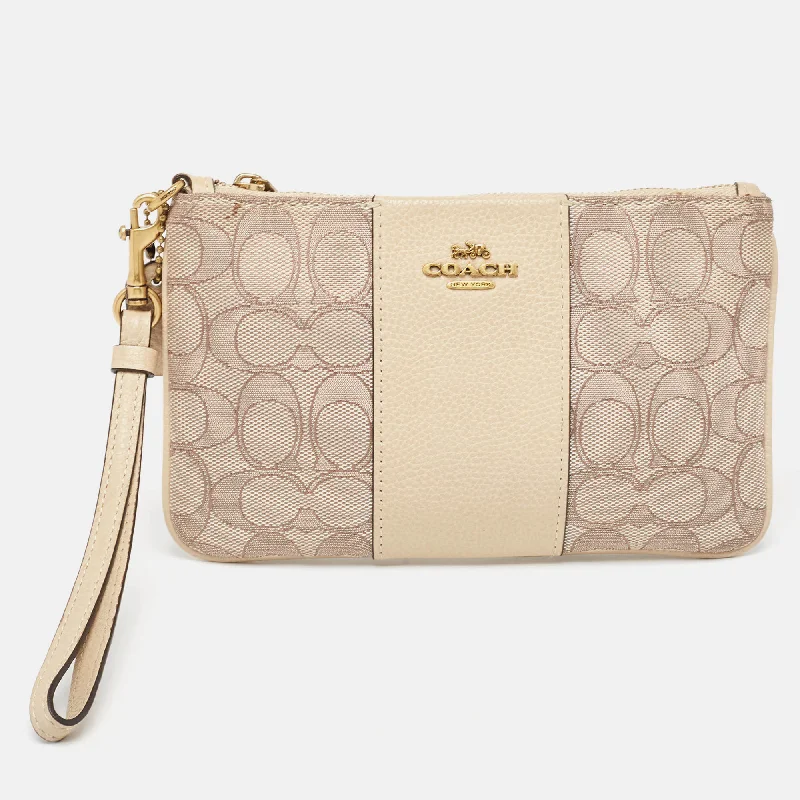 Coach Rogue bags with a monogram - embossed leather surfaceBeige Signature canvas and Leather Wristlet Zip Pouch