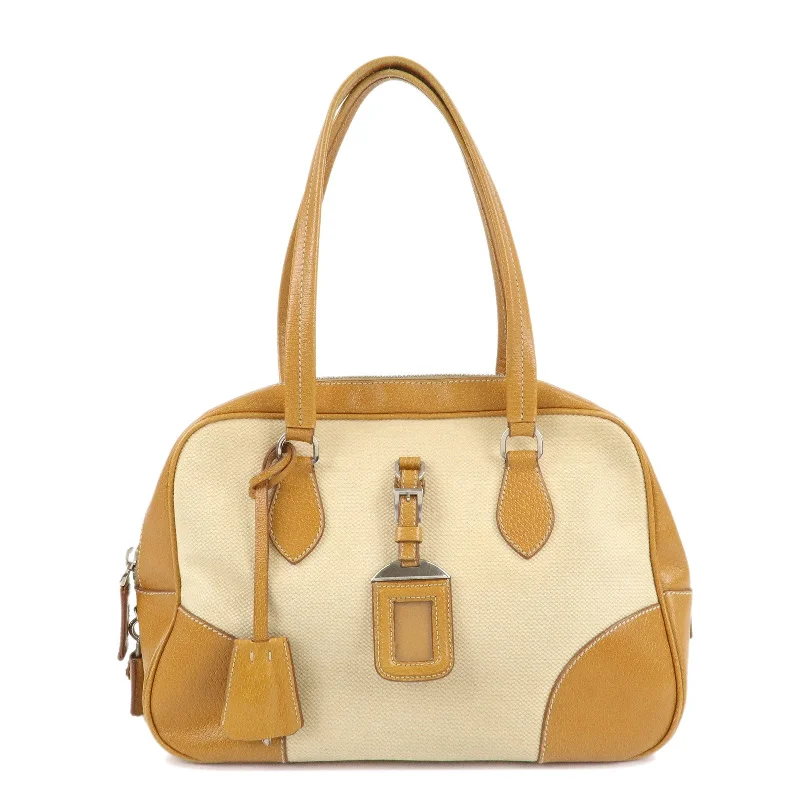 Prada Cleo bags with a contrast - colored interior for visual interestPRADA Canvas Leather Triangle Logo Boston Bag Ivory Brown