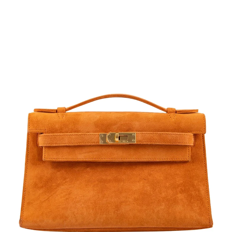 Hermès Kelly Bags with a hand - burnished edge finish for a vintage charmHermès Kelly Pochette Orange H Veau Doblis Suede with Gold Hardware